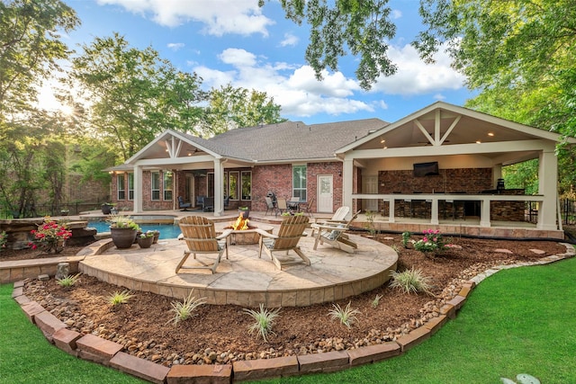 3806 W Benders Landing Blvd, Spring, TX 77386 - rear view of house featuring an outdoor fire pit, a patio area, an outdoor pool, brick siding, and a yard