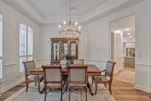 3806 W Benders Landing Blvd, Spring, TX 77386 - dining area featuring a chandelier, ornamental molding, light wood-type flooring, a tray ceiling, and baseboards