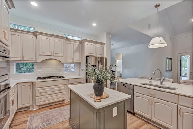 3806 W Benders Landing Blvd, Spring, TX 77386 - kitchen featuring stainless steel appliances, a sink, hanging light fixtures, tasteful backsplash, and light wood-style flooring