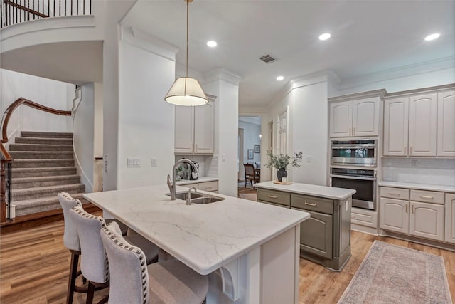3806 W Benders Landing Blvd, Spring, TX 77386 - kitchen with a sink, an island with sink, tasteful backsplash, double oven, and crown molding