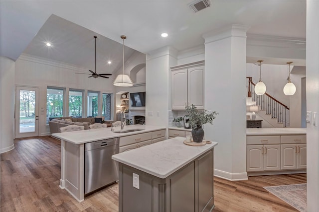 3806 W Benders Landing Blvd, Spring, TX 77386 - kitchen with dishwasher, a peninsula, a sink, light wood-style flooring, and open floor plan