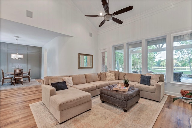 3806 W Benders Landing Blvd, Spring, TX 77386 - living room featuring a high ceiling, light wood finished floors, a ceiling fan, baseboards, and ornamental molding