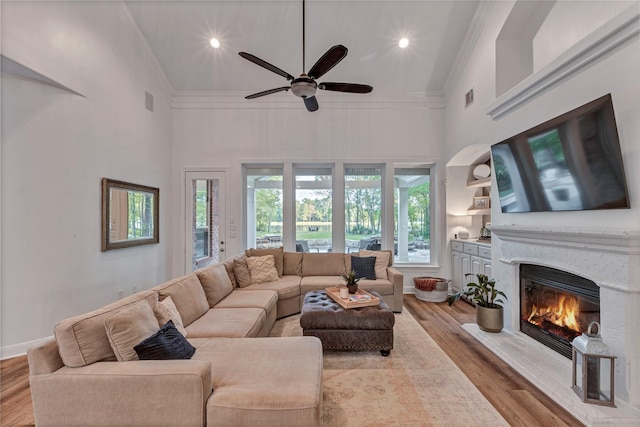 3806 W Benders Landing Blvd, Spring, TX 77386 - living area with crown molding, high vaulted ceiling, a ceiling fan, a glass covered fireplace, and wood finished floors