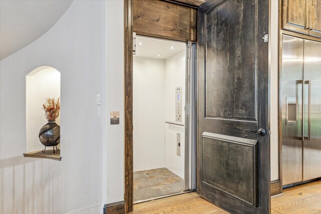 6619 Minola St, Houston, TX 77007 - elevator featuring built in refrigerator, wood finished floors, arched walkways, and recessed lighting
