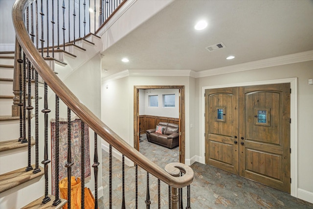 6619 Minola St, Houston, TX 77007 - foyer featuring crown molding, baseboards, stairs, stone finish floors, and recessed lighting