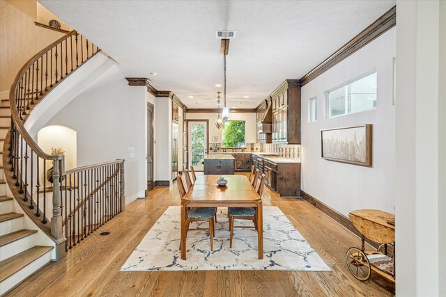 6619 Minola St, Houston, TX 77007 - dining space featuring ornamental molding, baseboards, stairs, light wood finished floors, and recessed lighting