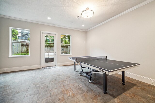 6619 Minola St, Houston, TX 77007 - game room featuring ornamental molding, plenty of natural light, a textured ceiling, and baseboards