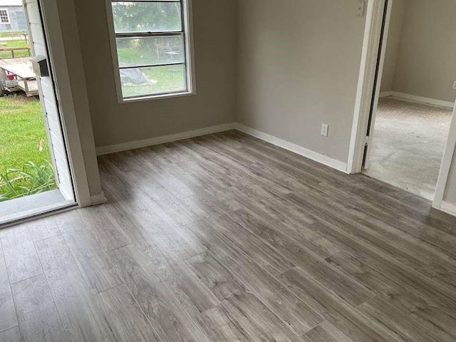 805 E Calhoun St, El Campo, TX 77437 - empty room with wood finished floors and baseboards