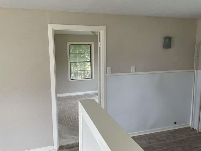 805 E Calhoun St, El Campo, TX 77437 - hall with baseboards, wood finished floors, and electric panel