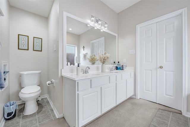 9303 Filaree Ridge Ln, Houston, TX 77089 - bathroom featuring double vanity, toilet, tile patterned flooring, and baseboards