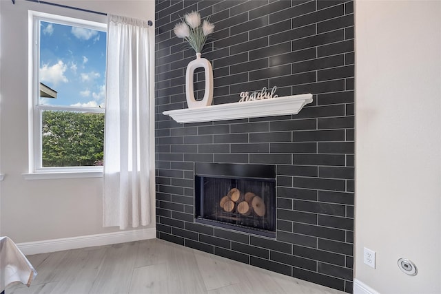 9303 Filaree Ridge Ln, Houston, TX 77089 - detailed view of baseboards, a fireplace, and wood finished floors