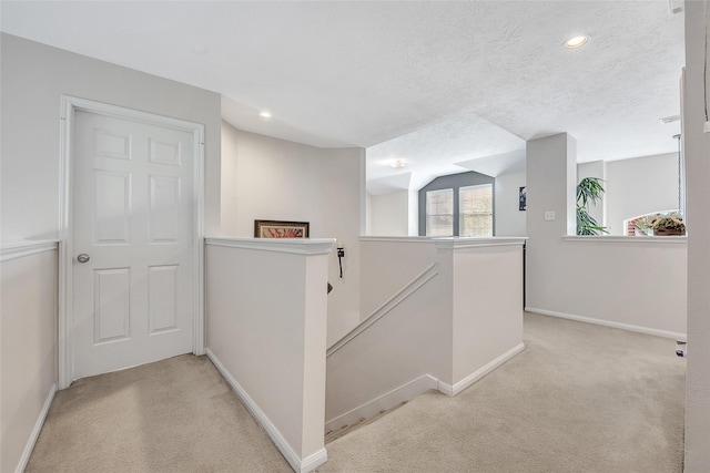 9303 Filaree Ridge Ln, Houston, TX 77089 - hall featuring an upstairs landing, light colored carpet, baseboards, recessed lighting, and a textured ceiling