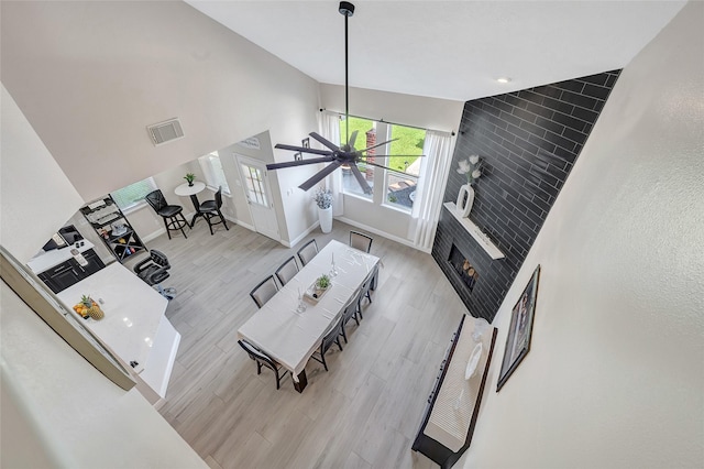9303 Filaree Ridge Ln, Houston, TX 77089 - living area with wood finished floors, baseboards, ceiling fan, and high vaulted ceiling
