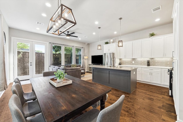 823 Mansfield St Unit E, Houston, TX 77091 - dining space with recessed lighting, dark wood-type flooring, a chandelier, and french doors