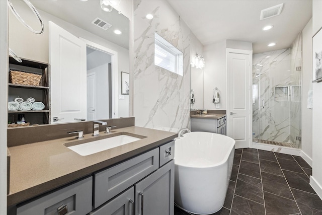823 Mansfield St Unit E, Houston, TX 77091 - bathroom with a marble finish shower, marble finish flooring, vanity, a soaking tub, and recessed lighting