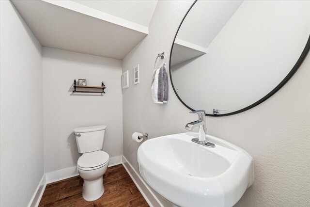823 Mansfield St Unit E, Houston, TX 77091 - half bath with toilet, wood finished floors, baseboards, and a sink