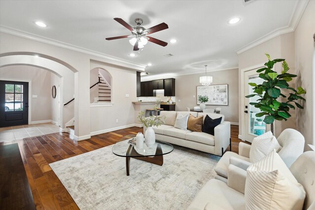 5250 Brinkman Ct, Houston, TX 77091 - living area with wood finished floors, baseboards, crown molding, arched walkways, and stairs