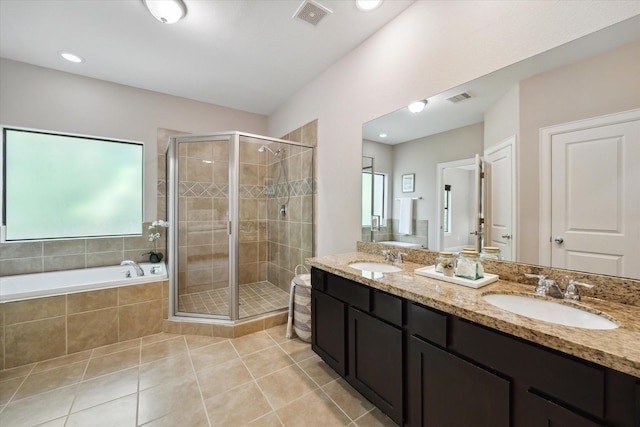 5250 Brinkman Ct, Houston, TX 77091 - full bath featuring a shower stall, double vanity, tile patterned flooring, and a bath