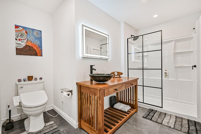 1805 Market St, Galveston, TX 77550 - bathroom featuring a stall shower, toilet, vanity, baseboards, and tile patterned flooring