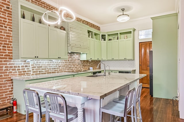 1805 Market St, Galveston, TX 77550 - kitchen with green cabinets, a sink, a breakfast bar area, dark wood-style flooring, and open shelves