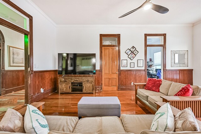 1805 Market St, Galveston, TX 77550 - living area featuring wainscoting, ornamental molding, wood finished floors, ceiling fan, and wood walls