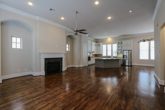 9642 Fannin Sta W, Houston, TX 77045 - living area with ornamental molding, a tile fireplace, baseboards, ceiling fan, and recessed lighting