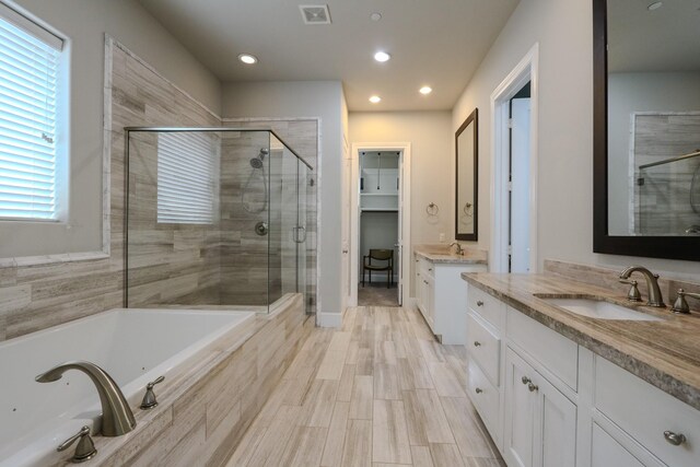 9642 Fannin Sta W, Houston, TX 77045 - bathroom with a shower stall, two vanities, a tub with jets, and recessed lighting