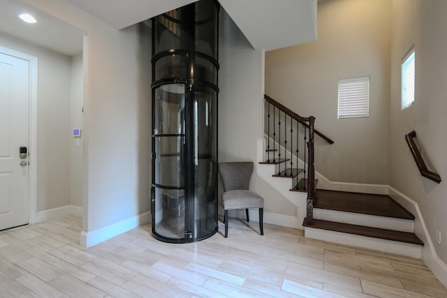 9642 Fannin Sta W, Houston, TX 77045 - foyer entrance with wood finished floors, stairway, and baseboards