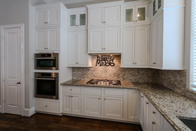 9642 Fannin Sta W, Houston, TX 77045 - kitchen featuring stainless steel appliances, white cabinetry, backsplash, and glass insert cabinets