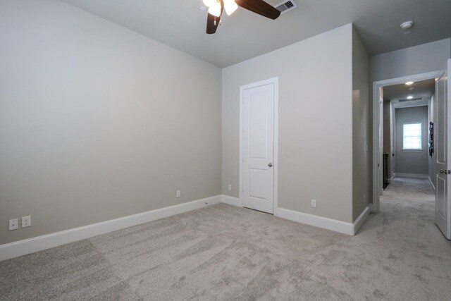 9642 Fannin Sta W, Houston, TX 77045 - unfurnished bedroom featuring light carpet, baseboards, and a ceiling fan