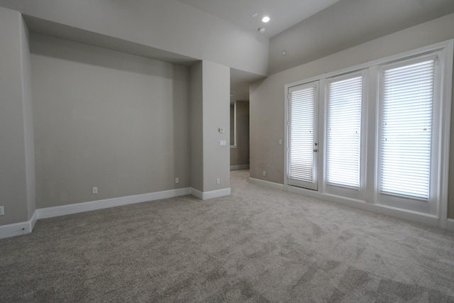 9642 Fannin Sta W, Houston, TX 77045 - empty room with light colored carpet, baseboards, recessed lighting, and lofted ceiling