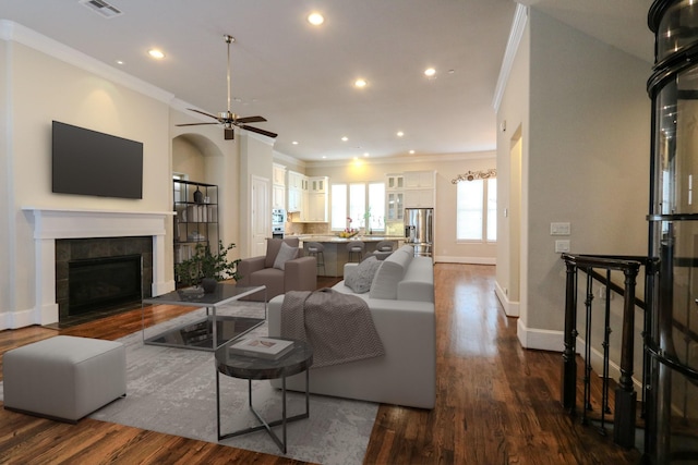 9642 Fannin Sta W, Houston, TX 77045 - living room featuring ornamental molding, dark wood-type flooring, a tile fireplace, recessed lighting, and baseboards