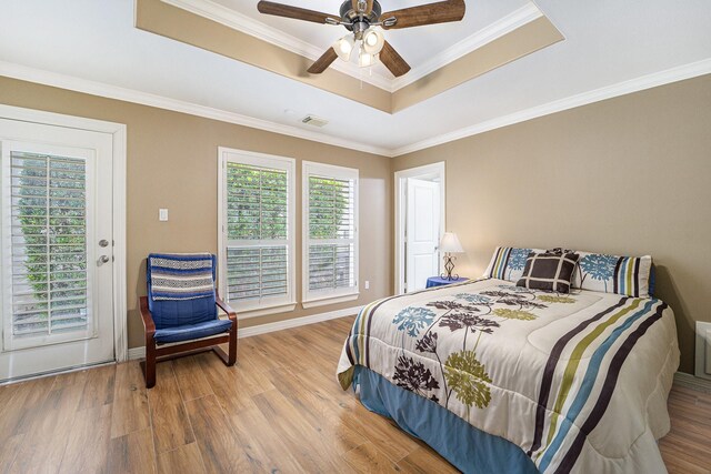 641 Hartman St, Houston, TX 77007 - bedroom with a tray ceiling, wood finished floors, crown molding, a ceiling fan, and baseboards