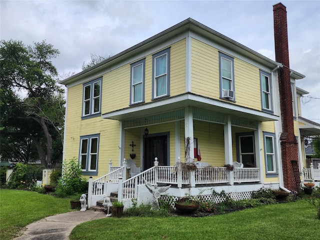 1017 Water St, Navasota, TX 77868 - view of front of home with a chimney, a porch, and a front lawn