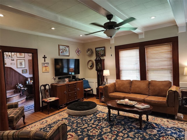 1017 Water St, Navasota, TX 77868 - living area featuring wood finished floors, beamed ceiling, crown molding, ceiling fan, and a wainscoted wall