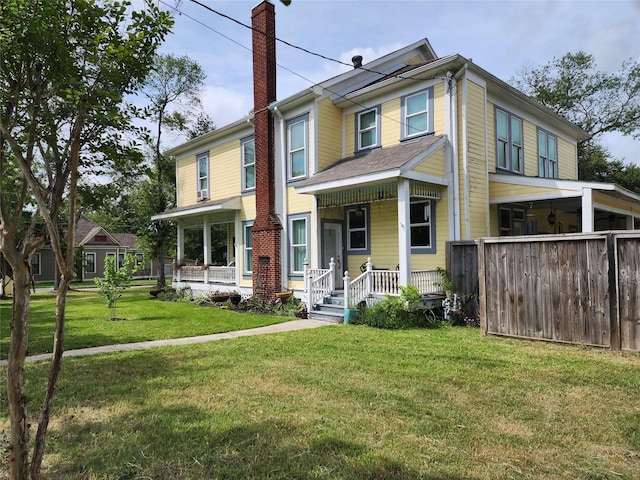 1017 Water St, Navasota, TX 77868 - view of front of home with a chimney, a porch, and a front yard