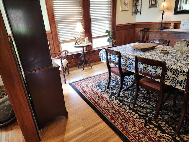 1017 Water St, Navasota, TX 77868 - dining room featuring a wainscoted wall, wooden walls, and light wood finished floors