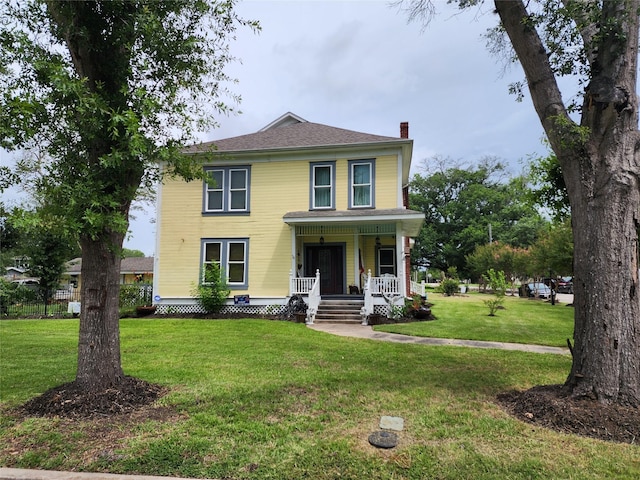 1017 Water St, Navasota, TX 77868 - american foursquare style home featuring a porch, a chimney, and a front yard