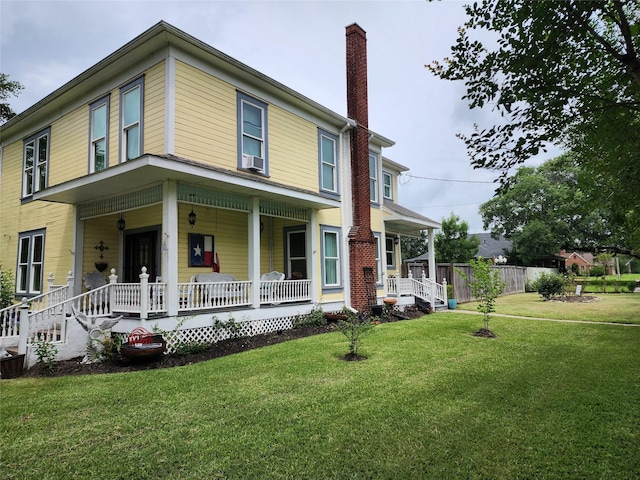 1017 Water St, Navasota, TX 77868 - view of front facade with a porch, a chimney, and a front lawn