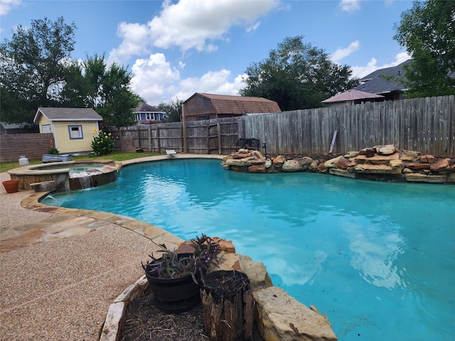 1017 Water St, Navasota, TX 77868 - view of swimming pool featuring a fenced backyard, a storage shed, and a pool with connected hot tub