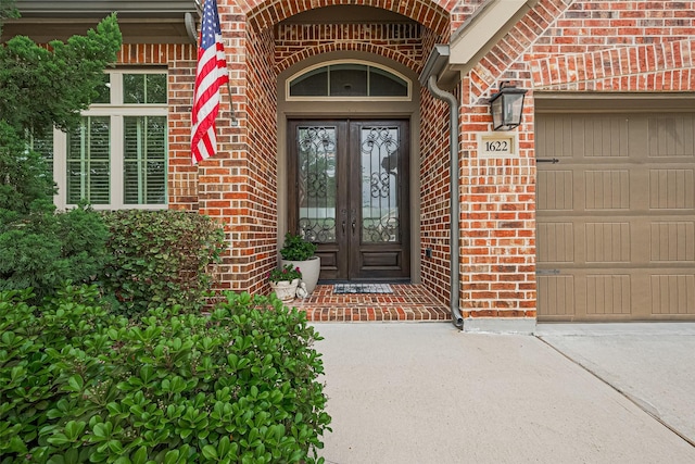 1622 Quail Ridge Dr, Katy, TX 77493 - property entrance with french doors, brick siding, an attached garage, and driveway