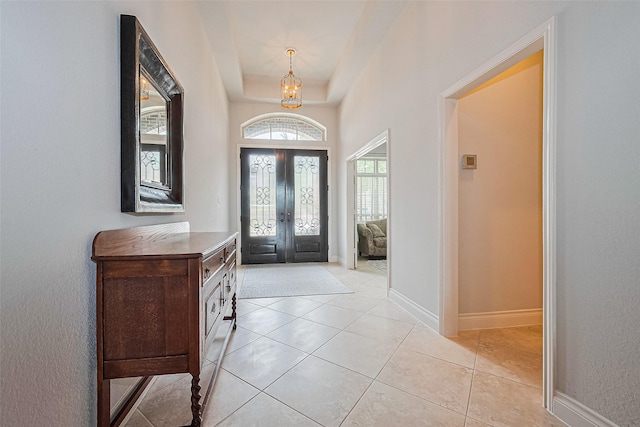 1622 Quail Ridge Dr, Katy, TX 77493 - foyer entrance with a chandelier, baseboards, light tile patterned floors, and a tray ceiling