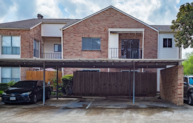 3726 Thistlemont Dr, Houston, TX 77042 - rear view of house featuring brick siding, covered parking, and a shingled roof