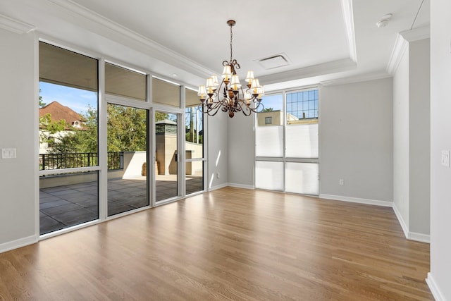 511 S Post Oak Ln Unit 2B, Houston, TX 77056 - spare room with a chandelier, wood finished floors, ornamental molding, baseboards, and a tray ceiling