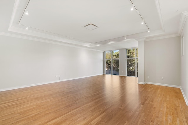 511 S Post Oak Ln Unit 2B, Houston, TX 77056 - unfurnished room featuring rail lighting, crown molding, a tray ceiling, and baseboards