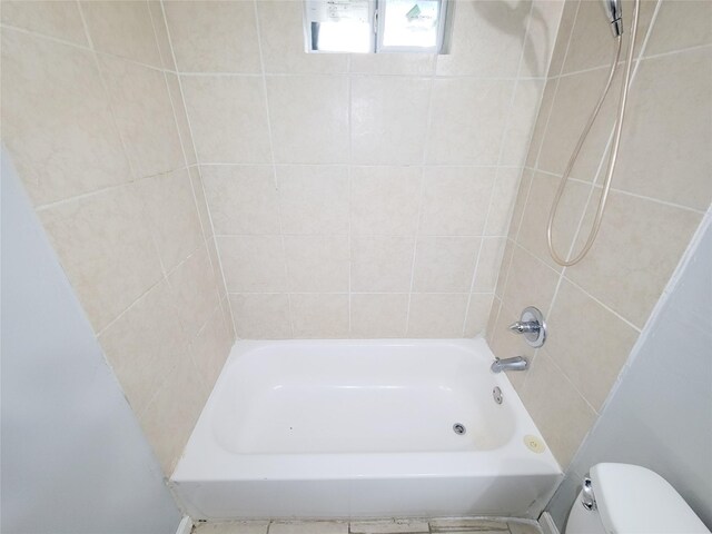 2928 Wayne St, Houston, TX 77026 - bathroom featuring toilet and shower / tub combination