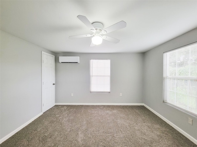 2928 Wayne St, Houston, TX 77026 - spare room with an AC wall unit, carpet, a ceiling fan, and baseboards