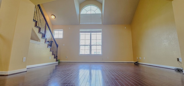 10722 Clearview Villa Pl, Houston, TX 77025 - unfurnished living room with plenty of natural light, wood-type flooring, stairs, and high vaulted ceiling