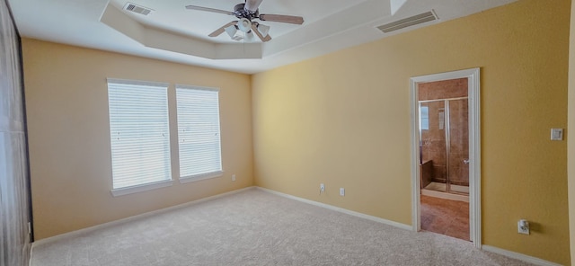 10722 Clearview Villa Pl, Houston, TX 77025 - carpeted empty room with plenty of natural light, a ceiling fan, and a tray ceiling