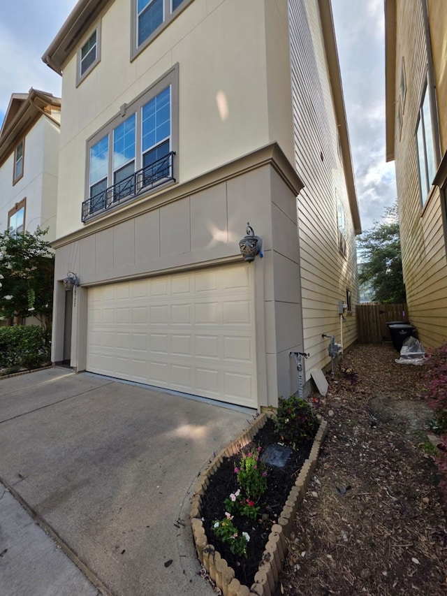 10722 Clearview Villa Pl, Houston, TX 77025 - view of home's exterior featuring a garage, driveway, and stucco siding